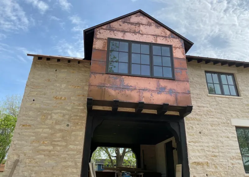 Copper metal panel facade on a stone building for Skylight Installation in Everman