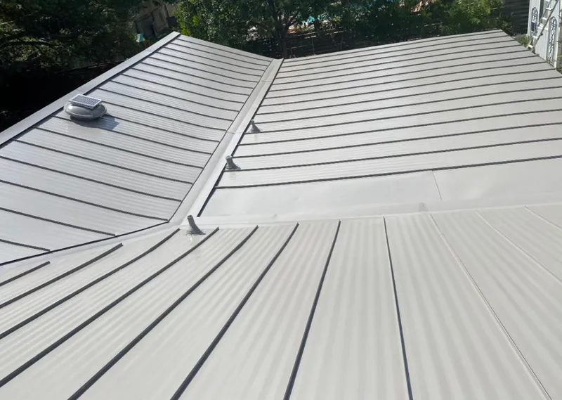 Solar attic fan installed on a metal roof for Roof Ventilation in Everman
